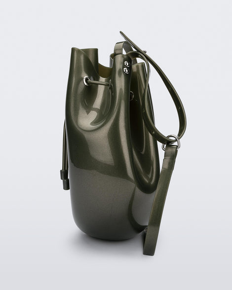 Side view of a metallic green Sac drawstring bag.