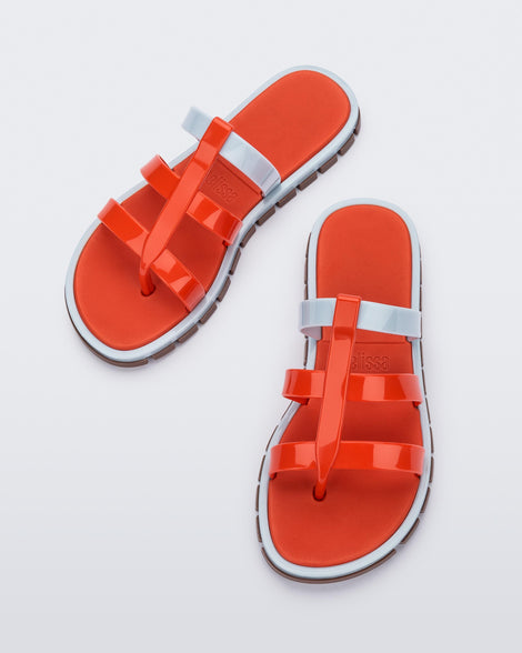 Top view of a pair of red Path adult sandals with  blue sole