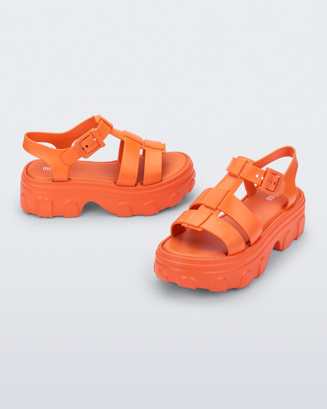 Angle view of a pair of orange Ella platform adult sandals