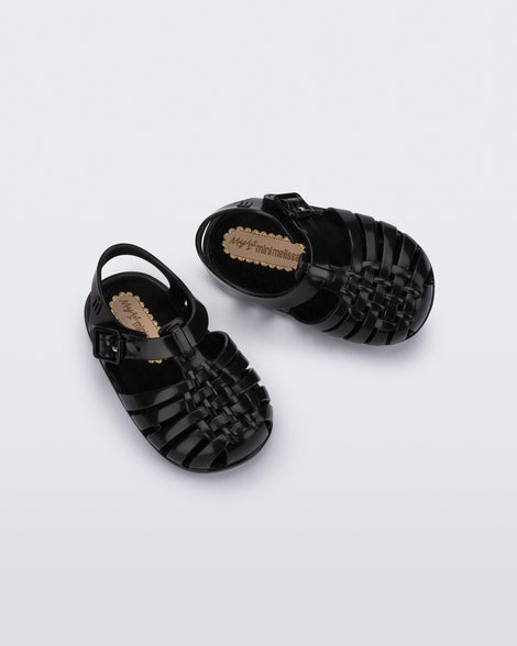 Top angled view of a pair of black baby My First Mini Melissa Possession sandals.