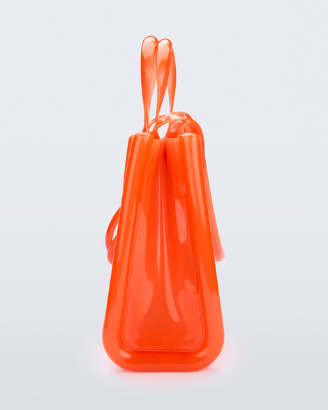 Side view of the orange Medium Jelly Shopper x Telfar bag