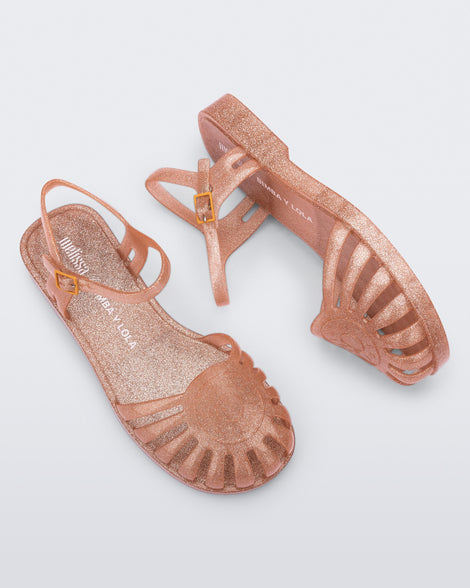 Top and side view of a pair of the glitter orange Sandal + Bimba y Lola with ankle strap