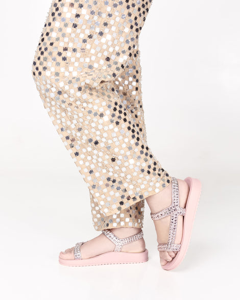 Model's legs in patterned pants wearing a pair of pink Lust sandals with rose gold strap