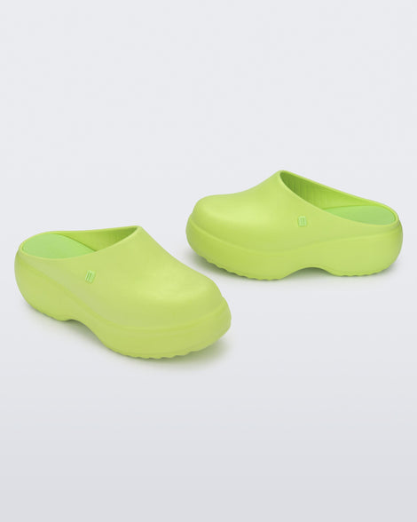 Side and angled view of a pair of green Free Clog Platforms