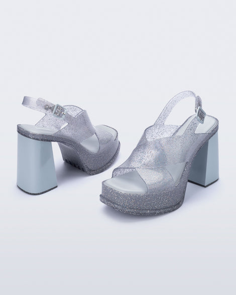 Angled view of a pair of clear glitter Dance Heel platforms