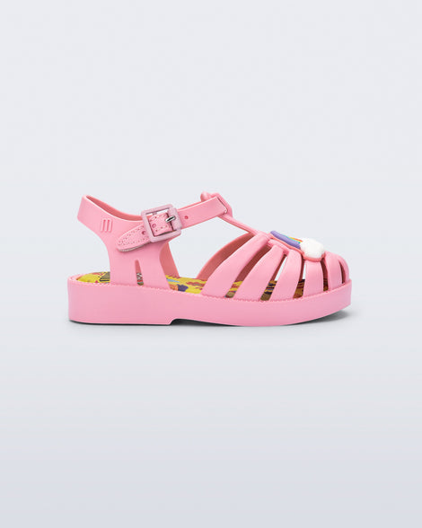 Side view of a matte pink baby Possession + Play Doh sandal