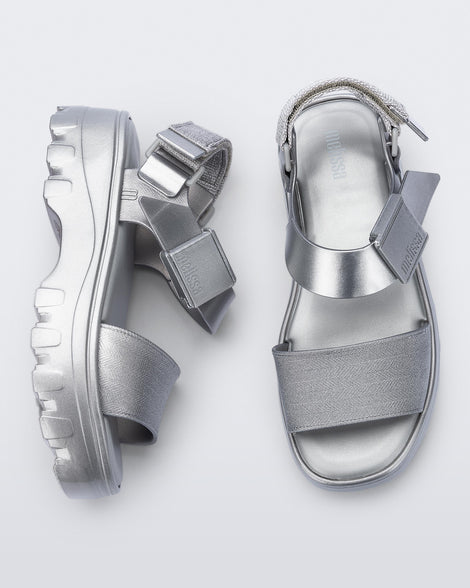 Top and side view of a pair of silver Kick Off Sandals