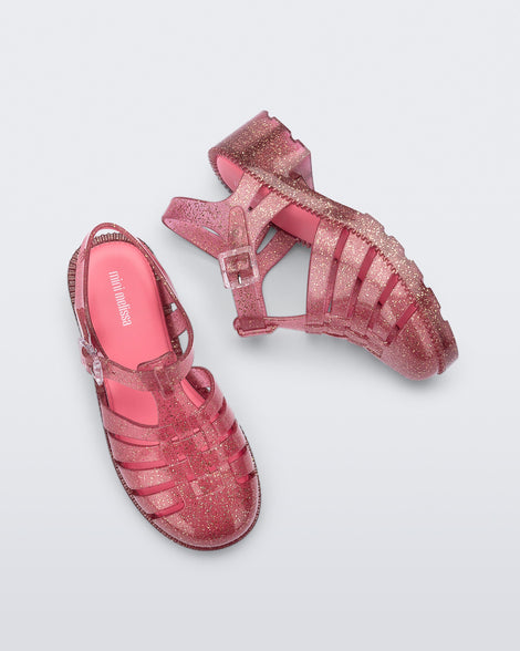 Top and side view of a pair of glitter pink kids Possession Heel sandals