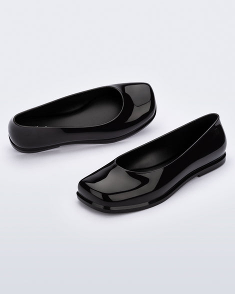 Angled view of a pair of black Ruby adult flats.