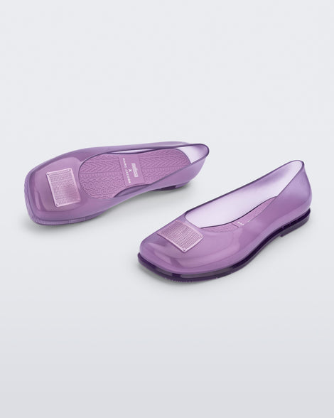 Side and angled view of a pair of lilac Ruby + Marc Jacobs flats