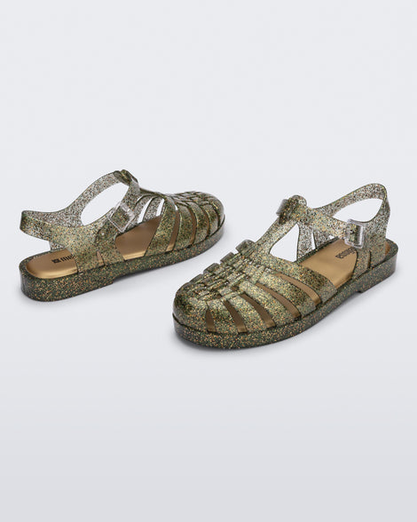 Top and angled view of a pair of glitter green Possession sandals