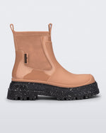 Side view of a brown Drip Boot with speckled black sole.