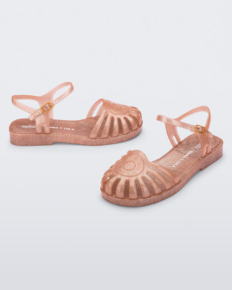 Angled view of a pair of the glitter orange Sandal + Bimba y Lola with ankle strap