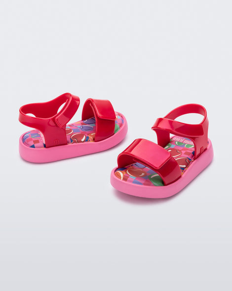 Angled view of a pair of pearly red baby Jump sandals