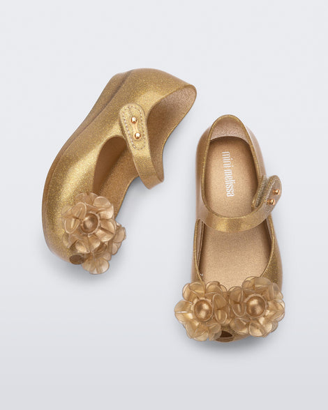 Top and side view of a pair of glitter beige baby Ultragirl Springtime flats