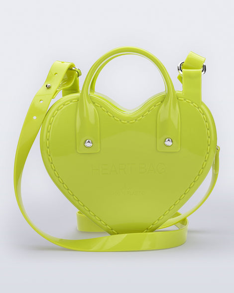 Back view of a green Heartbeat bag with small handles and longer strap.