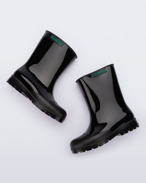 Side angled view of a pair of black kids Welly rainboots.