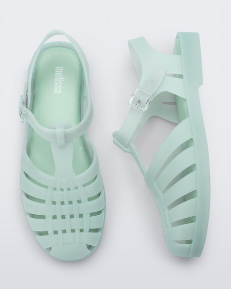 Side and top view of a pair of light green Possession sandals