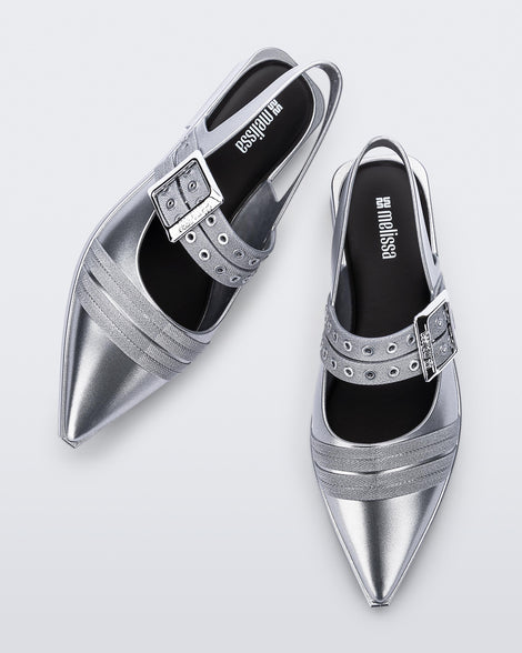 Angled and top view of a pair of silver Ladylike flats