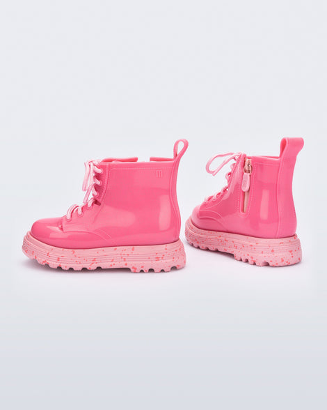 Back and side view of a pair of pink Coturno baby boots with pink laces.