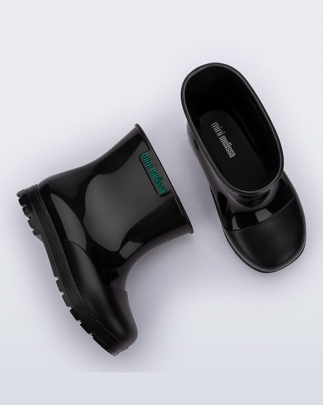 Side and top view of a pair of black baby Welly rainboots.