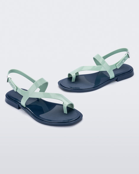 Angled view of pair of green Cassie sandals.