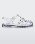 Side view of a clear Possession Studs fisherman sandal with silver studs.