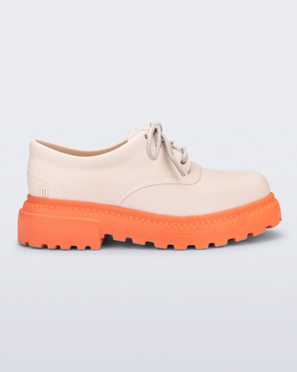 Side view of a beige with orange sole Charlotte adult sneaker loafer with laces