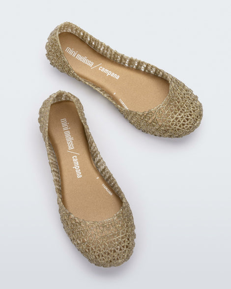 Top view of a pair of gold glitter Mini Melissa Campana flats with a woven detail base.