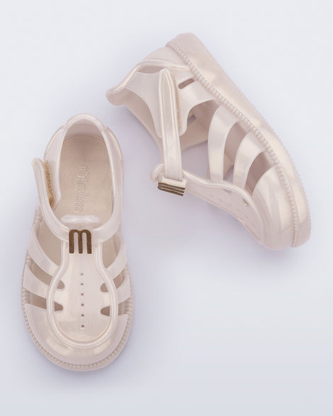 Top and side view of a pair of metallic beige baby Hip Daydream sandals