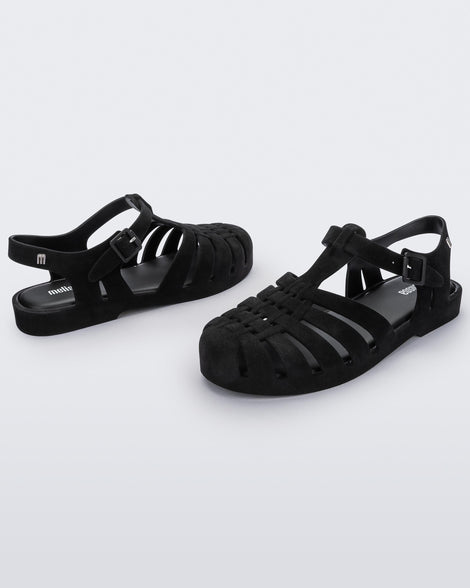 Angled view of a pair black flocked Melissa Possession Velvet sandals.