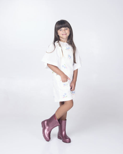 Child model wearing a pair of glitter pink kids Welly rainboots.