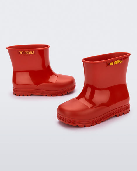 Angled view of a pair of red baby Melissa Welly boots.