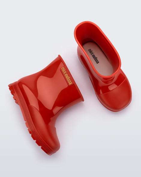 Top and side view of a pair of red baby Melissa Welly boots.