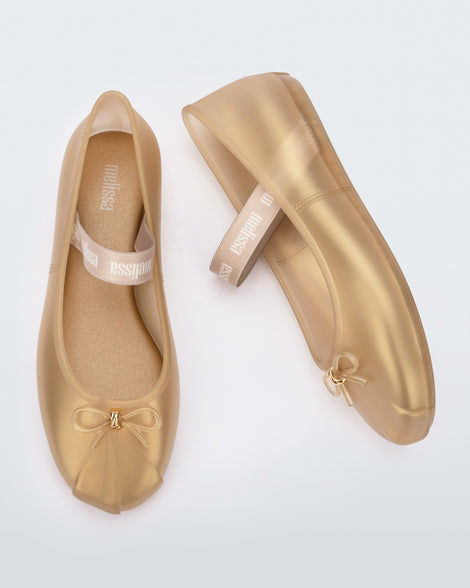 Side and top view of a pair of gold Sophie flats.