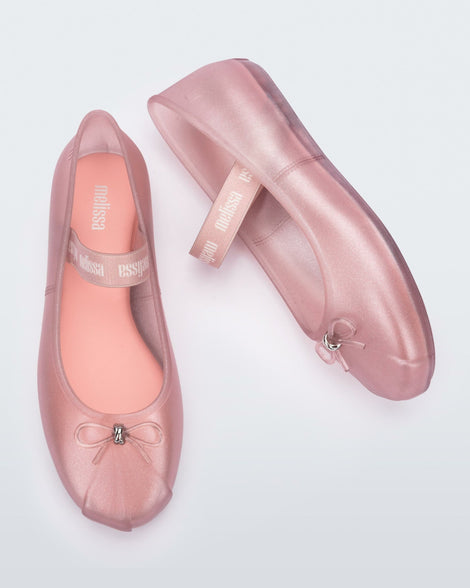 Top and side view of a pair of glitter pink Sophie flats.