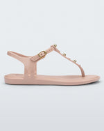 Side view of a pink Melissa Solar studs sandal with gold studded t-strap and gold buckle.
