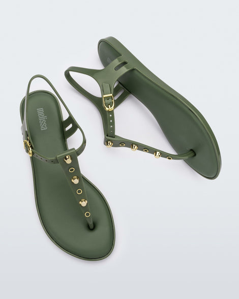 Top and side view of a pair of green Melissa Solar studs sandals with gold studded t-strap and gold buckle.