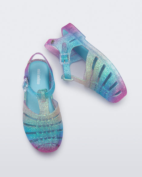 Top and side view of a pair of pink and blue glitter kids Possession sandals.