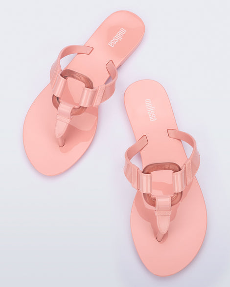 Top view of a pair of pink Olivia adult flip flops