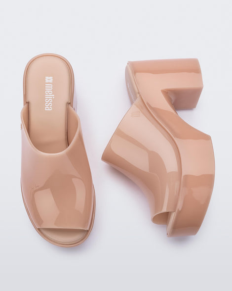 Top and side view of a pair of pink Mule Hype heel platforms