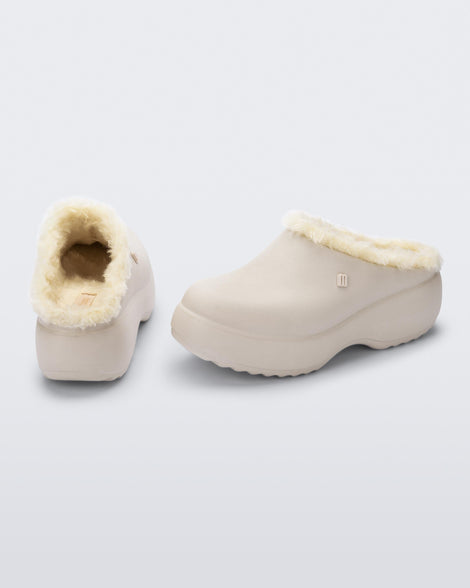 Back and side view of a pair of beige Free Clog Fluffy Platforms with light beige fluffy liner