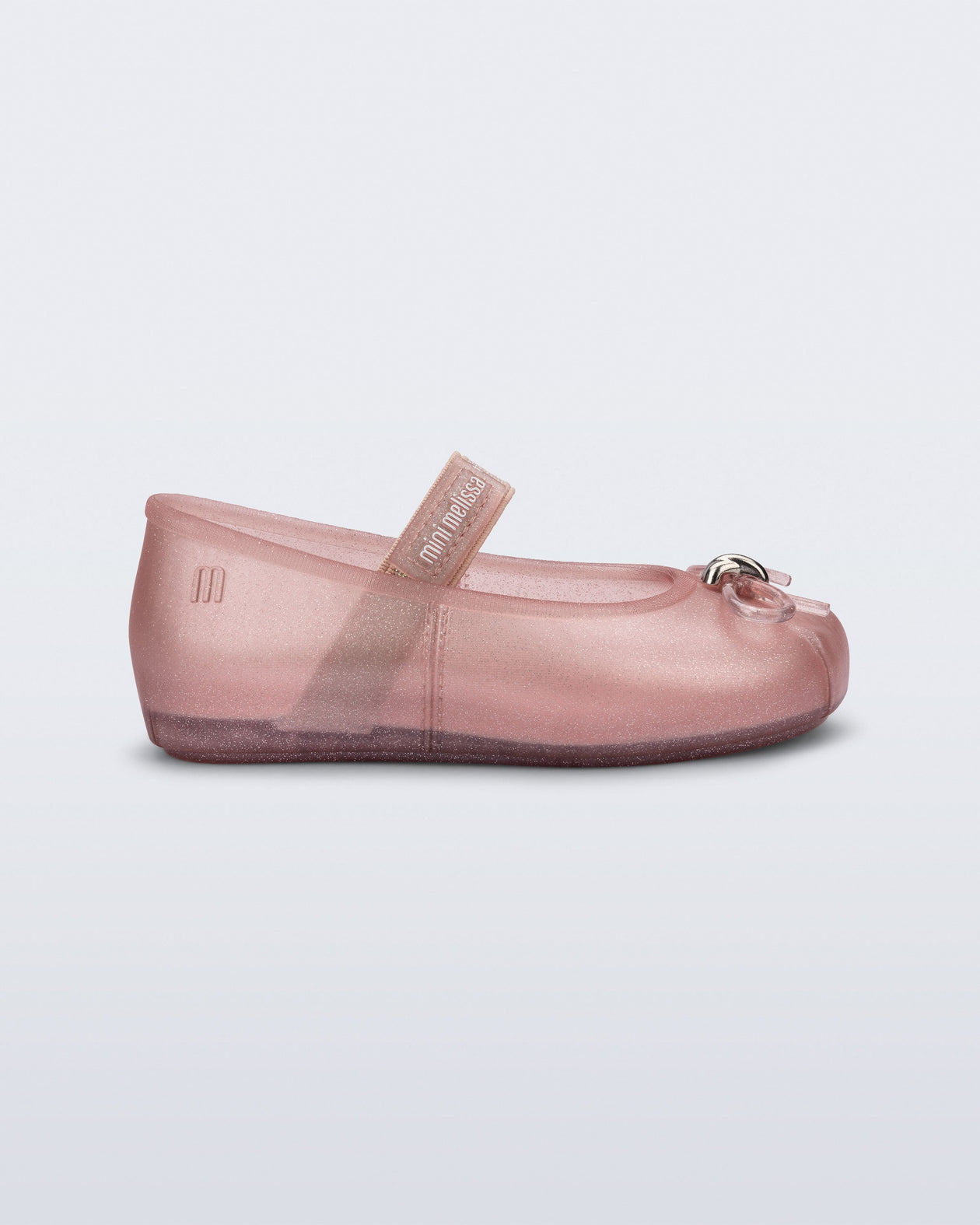 Side view of a pearly pink Sophie baby ballerina flat with bow