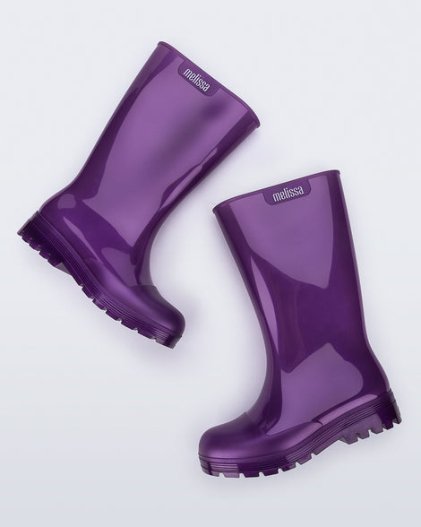 Side angled view of a pair of purple Welly rainboots.