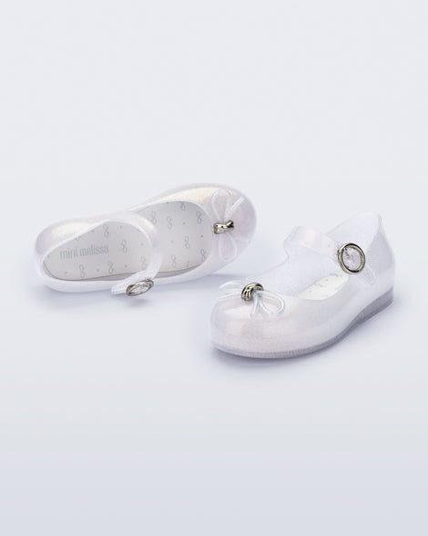 Top and angled view of a pair of pearly clear baby Sweet Love flats