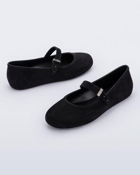 Side angled view of a pair of black Soft Ballerina Velvet flats