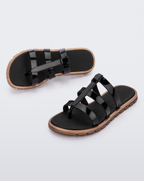 Top and angled view of a pair of black Path adult sandals with  gold sole