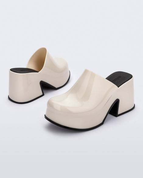 Back and front angled view of a pair of beige Mia Platform Mule Heels with black sole