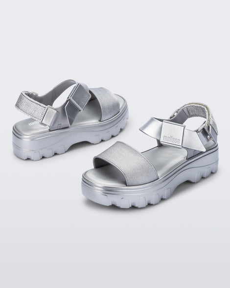 Angled view of a pair of silver Kick Off Sandals