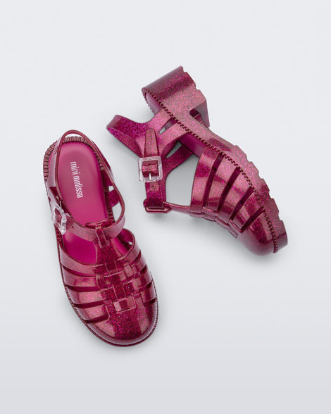 Top and side view of a pair of glitter dark pink kids Possession Heel sandals